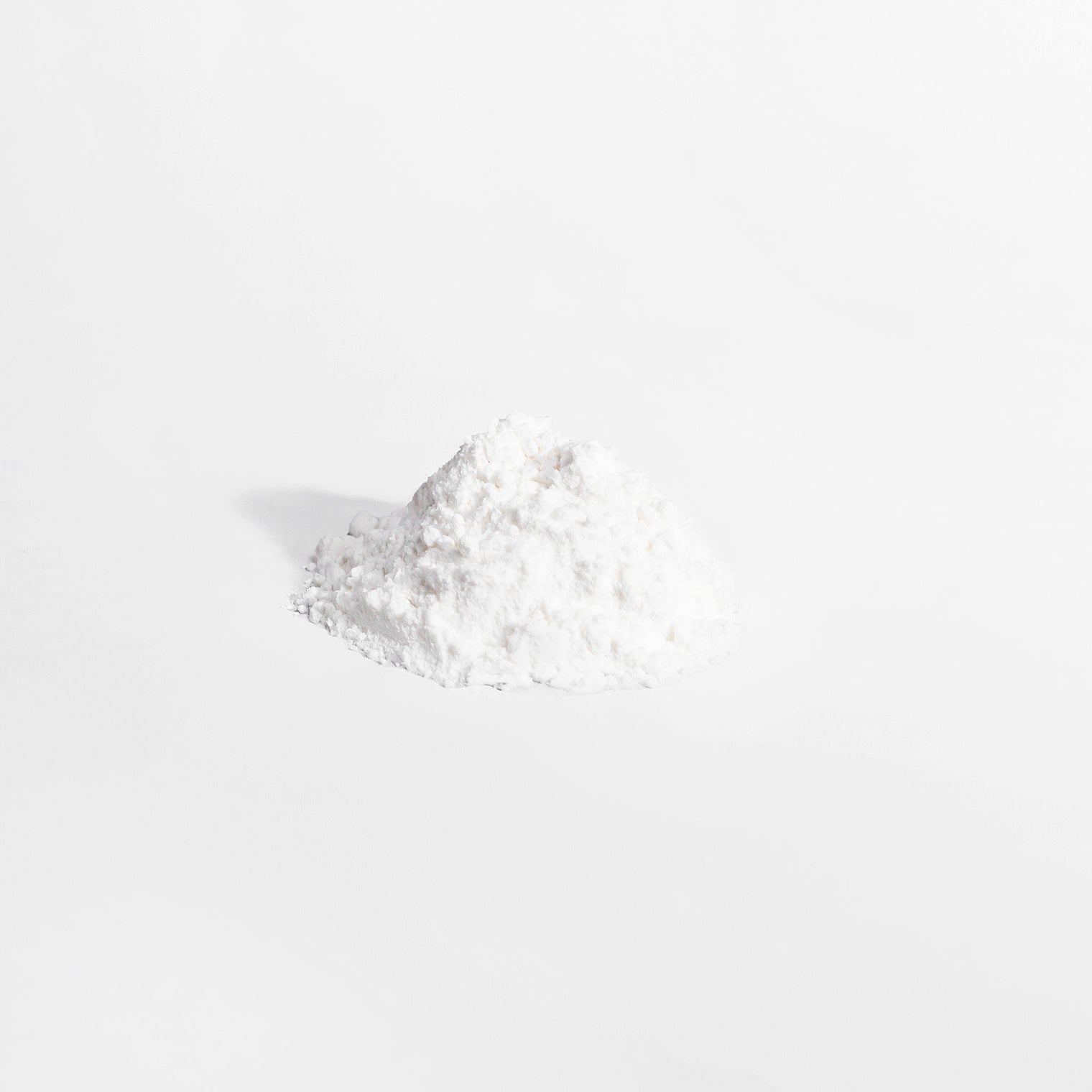 A scoop of white L-Glutamine powder from Thrive Hive's unflavored supplement.