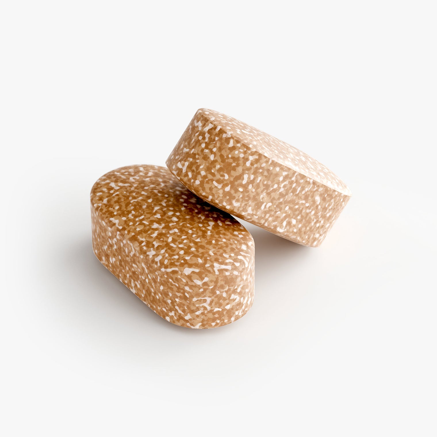 Close-up of a Thrive Hive Men's Vitality tablet, a proprietary blend of vitamins and herbs.