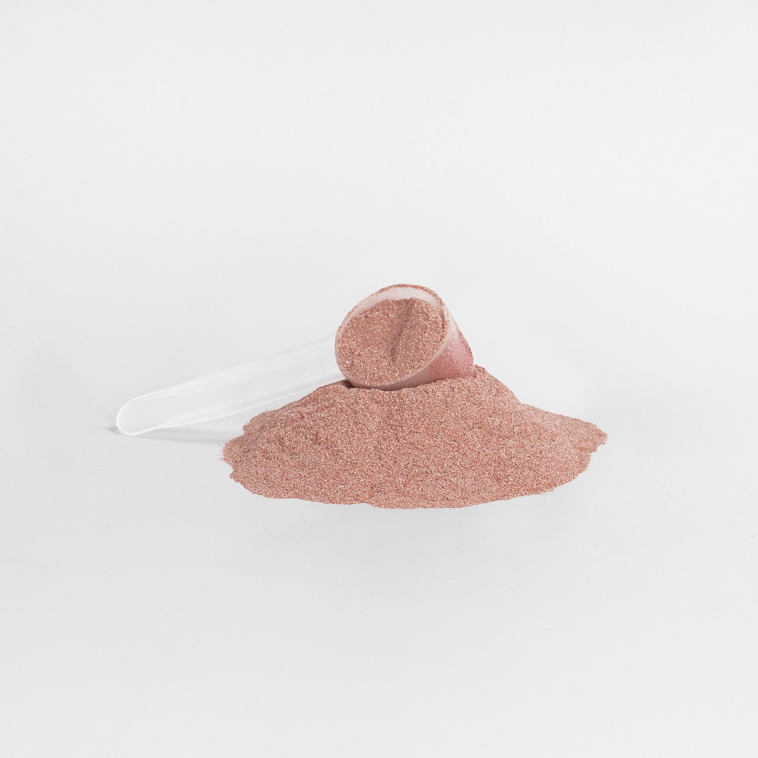 A scoop of rich red powder from Thrive Hive's antioxidant superfood blend.