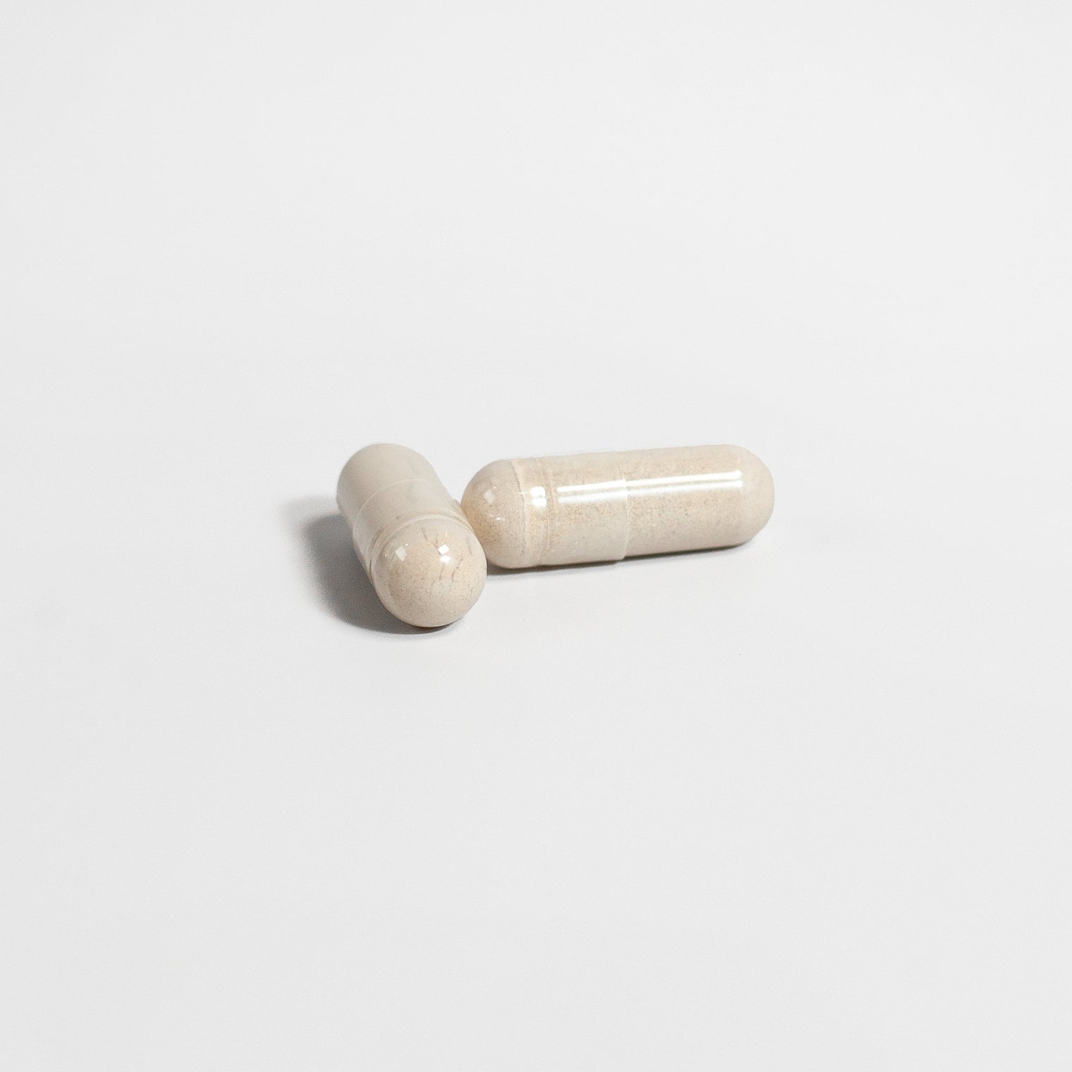 Close-up of a Thrive Hive Alpha Male capsule, a herbal blend for men's health.
