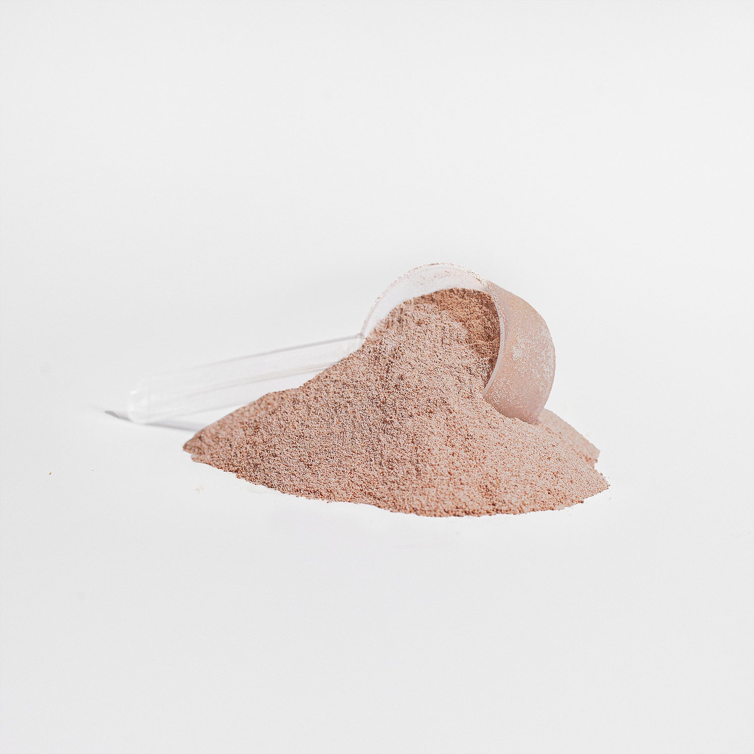 A scoop of chocolate-flavored collagen powder being added to a drink.