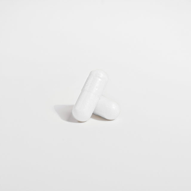 Close-up of a Thrive Hive Magnesium Glycinate capsule, a highly bioavailable supplement.