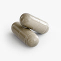 Close-up of a Thrive Hive Daily Detox capsule showing the natural ingredients inside.